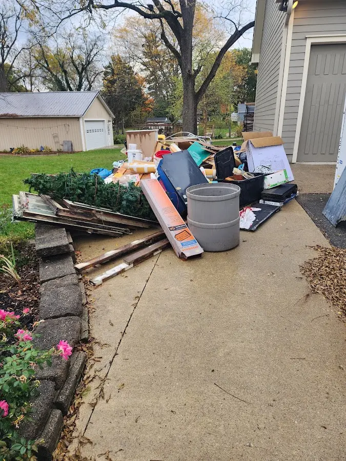 Dumpster being loaded with debris for Estate Cleanout Dumpster Rental in Grayson